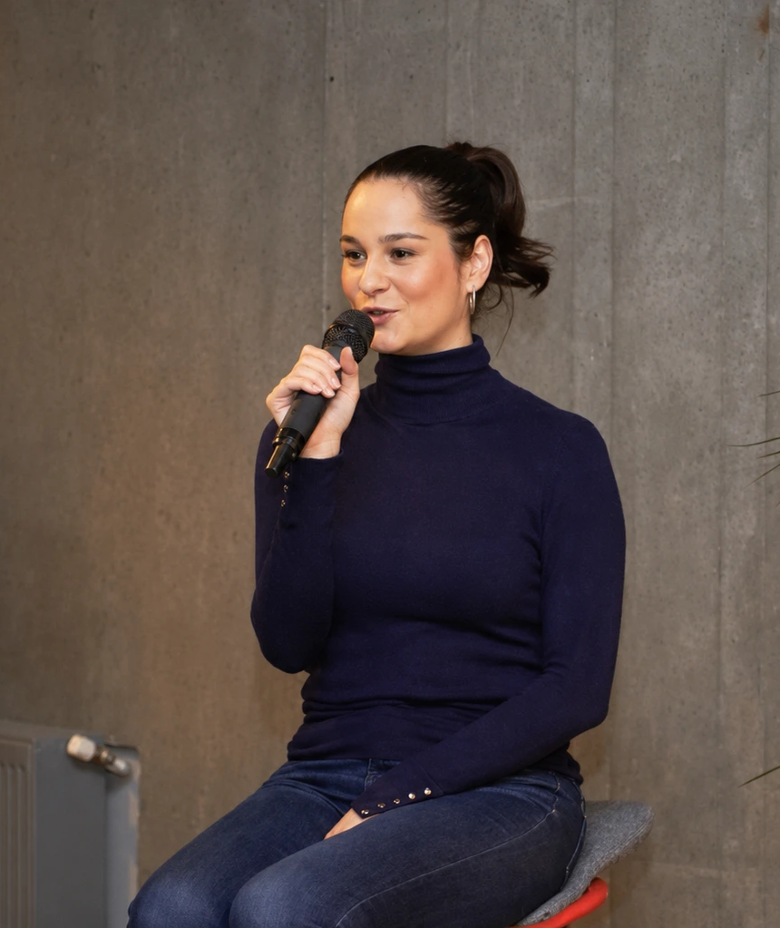 Nicoleta Marian speaking into a microphone at an event